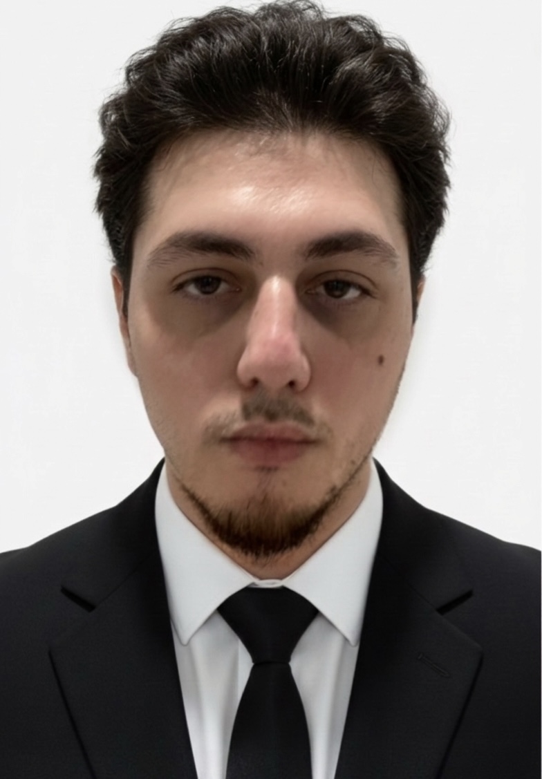 Portrait of Mahammad Hasanov in a black suit and tie